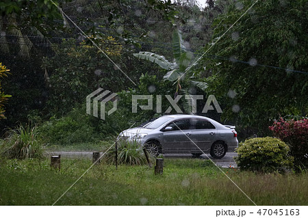 The car run in the rain on the road in countryside The car run in the rain on the road in countryside 47045163