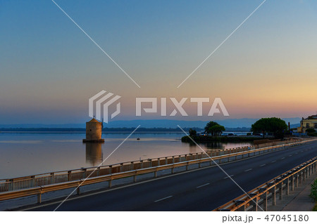 Old Spanish windmill in lagoon Orbetello at sunise 47045180