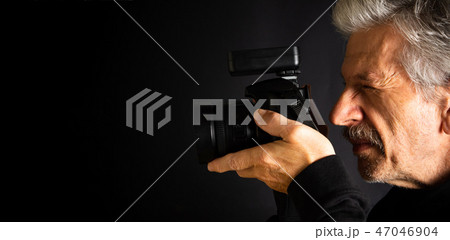 Senior using a camera close up 47046904