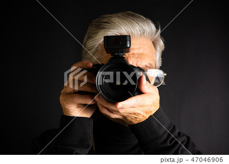 Senior using a camera close up 47046906
