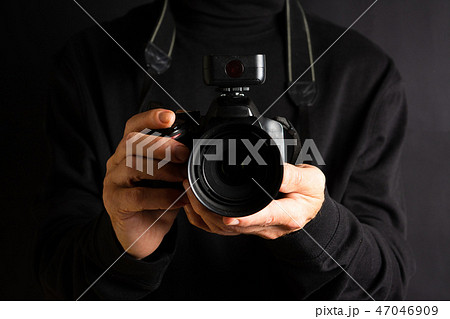 Person holding a camera close up 47046909