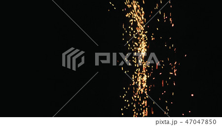 hot sparks slowly falling from above black background 47047850