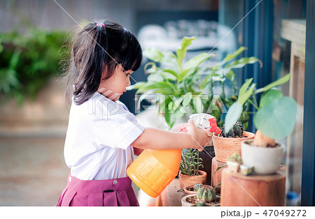 Happy Cute Asian Girl Enjoying with Gardening Happy Cute Asian Girl Enjoying with Gardening 47049272