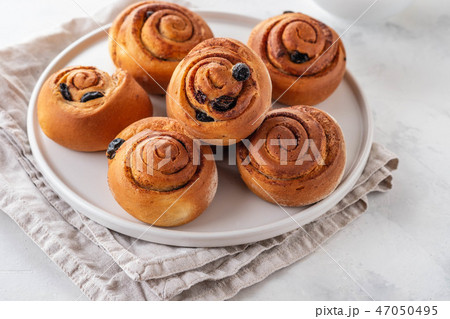 Freshly Baked Traditional Sweet Cinnamon Rolls, Swirl on white plate. Copy space. 47050495