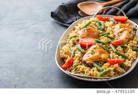 Grilled chicken thighs with bulgur, asparagus beans and tomatoes. Delicious lunch. Grilled chicken thighs with bulgur, asparagus beans and tomatoes. Delicious lunch. 47051130
