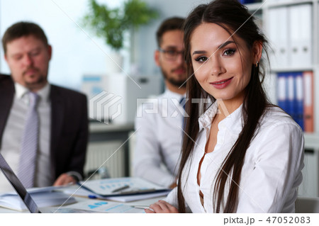 Beautiful smiling brunette clerk girl at workplace Beautiful smiling brunette clerk girl at workplace 47052083