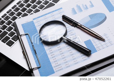Office workplace with magnifier and stationery Office workplace with magnifier and stationery 47052261
