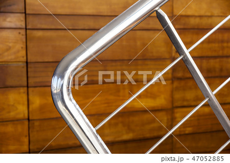 Marine steel railings on a boat on a bright sunny day with blue water and sky in the background. Marine steel railings on a boat on a bright sunny day with blue water and sky in the background. 47052885