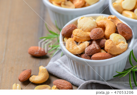salted cocktail nuts on wood background 47053206