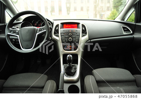 Modern luxury prestige car interior, dashboard, steering wheel. Black perforated leather interior. Modern luxury prestige car interior, dashboard, steering wheel. Black perforated leather interior. 47055868
