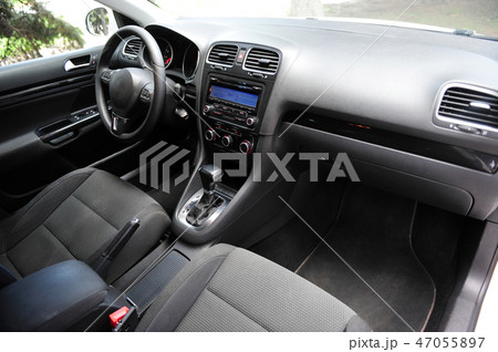 Modern luxury prestige car interior, dashboard, steering wheel. Black perforated leather interior. 47055897