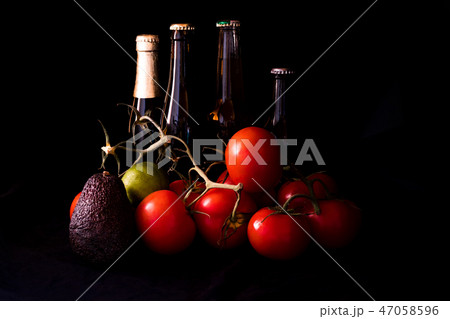 large red and ripe tomatoes with lime avocado and  47058596