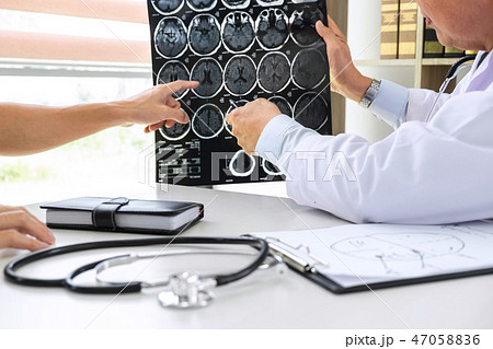 Professor Doctor having conversation with patient and holding x- 47058836