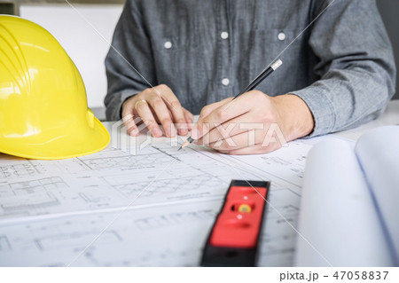 Construction engineering or architect hands working on blueprint 47058837