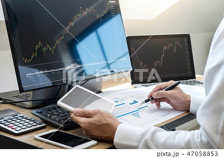 Stock exchange market concept, stock broker looking at graph wor Stock exchange market concept, stock broker looking at graph wor 47058853
