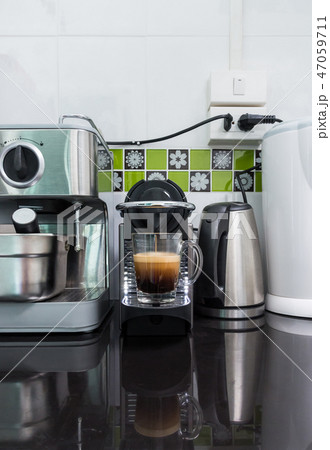Small coffee machine is making the espresso coffee Small coffee machine is making the espresso coffee 47059711