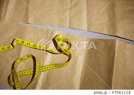 Yellow centimeter lies on the patterns.Sewing clot 47061118