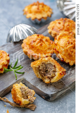 Homemade mini-pies with meat filling. 47061595