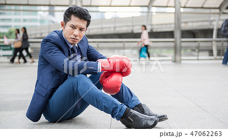 A man sit alone and tiring after fighting  47062263
