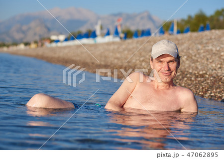 Happy man in sea Happy man in sea 47062895