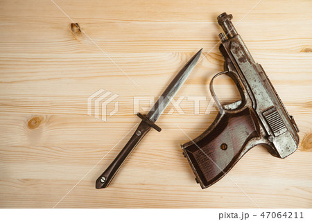 the gun is on the table 47064211