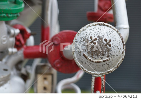 Smiley face on the pipes construction 47064213
