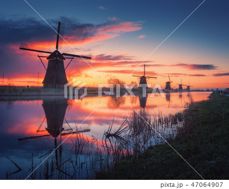 Windmills at beautiful sunrise in Netherlands Windmills at beautiful sunrise in Netherlands 47064907