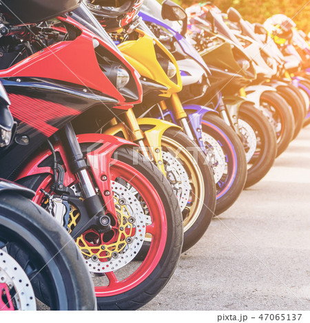 Motorcycles group parking on city street in summer Motorcycles group parking on city street in summer 47065137