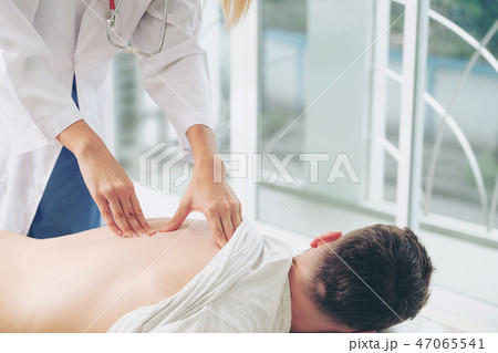 Woman Doctor and Male Patient in Hospital Office 47065541