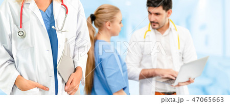 Doctor working in hospital with other doctors. 47065663