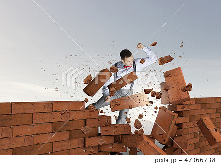 Businessman crashing bricks 47066738