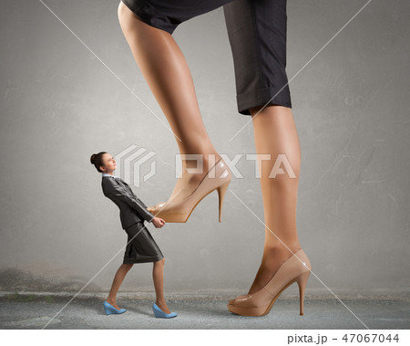 Big boss woman steping on colleague 47067044