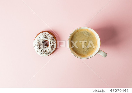 iced donut with chocolate decor and cup  47070442