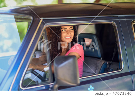Young Arab woman driving an old van in nature 47073246