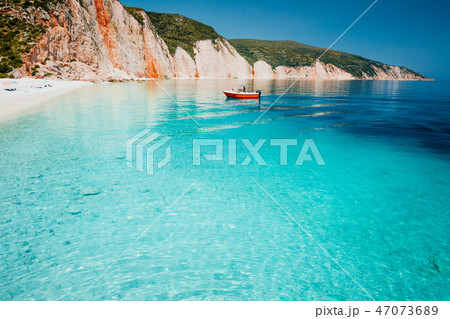 Tourist pleasure boat land to beautiful remote white pebble beach with transparent clear blue sea Tourist pleasure boat land to beautiful remote white pebble beach with transparent clear blue sea 47073689