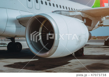 Turbine of passenger jet that waiting for departure in airport in warm afternoon light Turbine of passenger jet that waiting for departure in airport in warm afternoon light 47073738