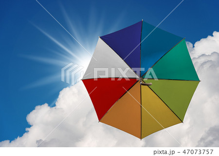 Multicolor umbrella flying in the sky Multicolor umbrella flying in the sky 47073757