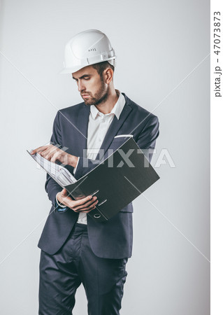 Engineer turning pages in folder 47073873