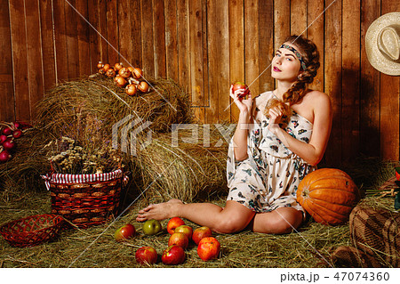 Girl in rustic barn Girl in rustic barn 47074360