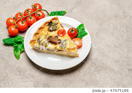 Slice of traditonal homemade spinach chicken quiche tart or pie on plate Slice of traditonal homemade spinach chicken quiche tart or pie on plate 47075166