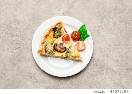 Slice of traditonal homemade spinach chicken quiche tart or pie on plate Slice of traditonal homemade spinach chicken quiche tart or pie on plate 47075168