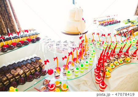 Delicious sweets on wedding candy buffet with desserts, cupcakes Delicious sweets on wedding candy buffet with desserts, cupcakes 47078419
