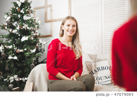 Merry Christmas and Happy Holidays. Cheerful mom and her cute daughter girl exchanging gifts 47079065