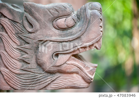 Stone dragon head scultpure close-up 47083946