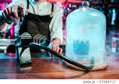 Expert barman is making cocktail at night club. Expert barman is making cocktail at night club. 47084717