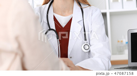 Hand of doctor  reassuring her female patient 47087158