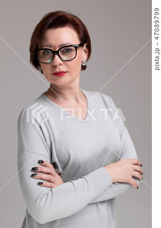 Portrait of beautiful woman with glasses isolated on light background 47089799