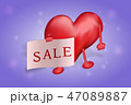 The figure of heart holds in the hands of a poster with the inscription of the sale on a red 47089887