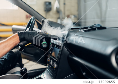 Carwash, removing dust and dirt with steam cleaner Carwash, removing dust and dirt with steam cleaner 47090855