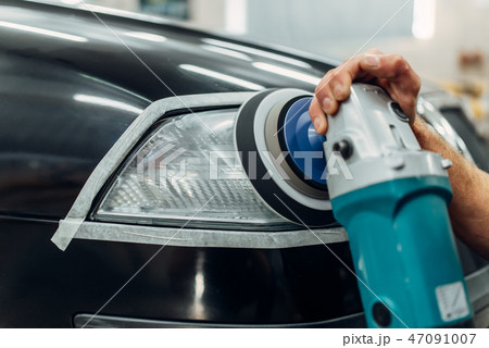 Auto detailing, worker with polishing machine Auto detailing, worker with polishing machine 47091007